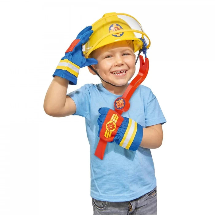 Boy dressed up in Fireman Sam gloves and helmet, holding a red crowbar