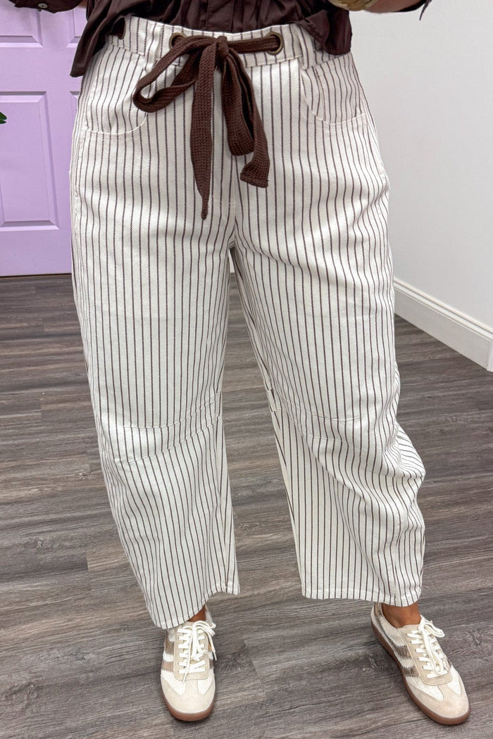 brown and off white striped wide barrel leg denim pants with button/zipper and drawstring closure