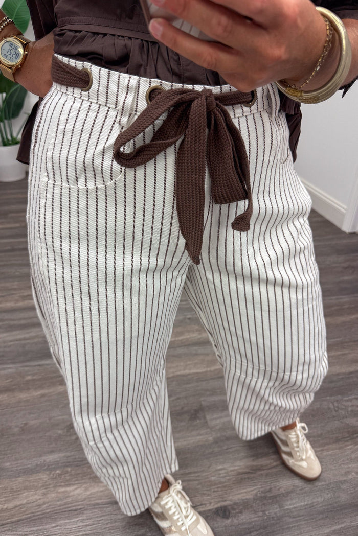 brown and off white striped wide barrel leg denim pants with decorative drawstring and front pockets