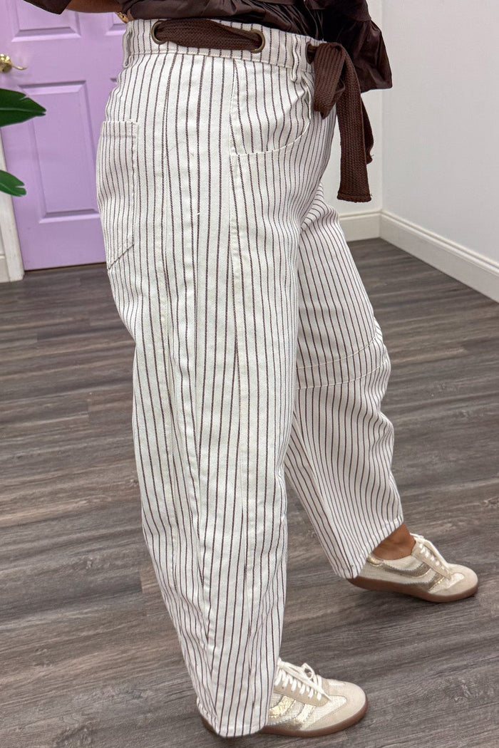 brown and off white striped wide barrel leg denim pants with decorative drawstring and belt loops