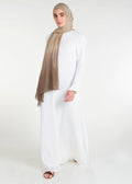 Long Line Abaya in Classic White, featuring a flattering silhouette that effortlessly complements your style. Experience comfort and sophistication in every step with this must-have addition to your modest collection.