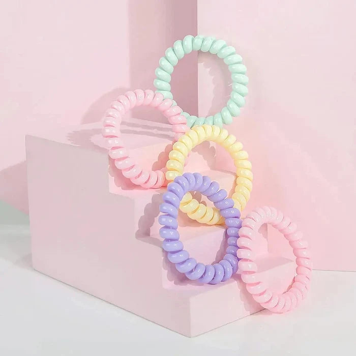5 pastel colour spiral hair bobbles on a pink display step unit