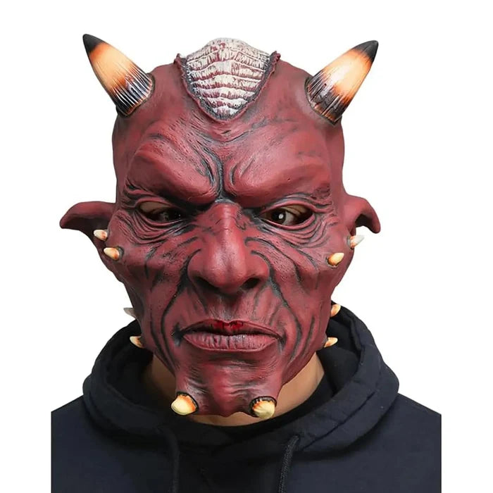 Model wearing a red devil mask with horns and pointed ears for fancy dress costumes