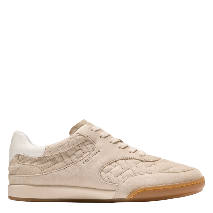 Beige sneaker with brown sole on a white background