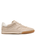 Beige sneaker with brown sole on a white background